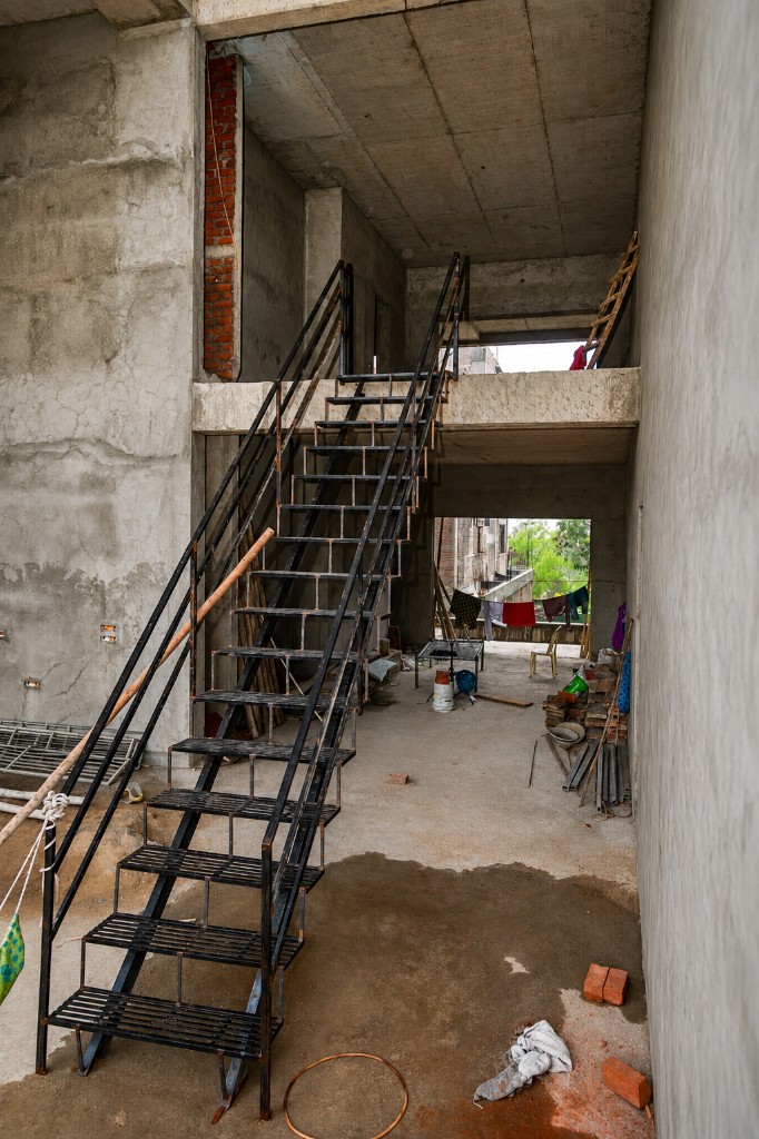 Metal staircase framing inside solar factory structure during construction